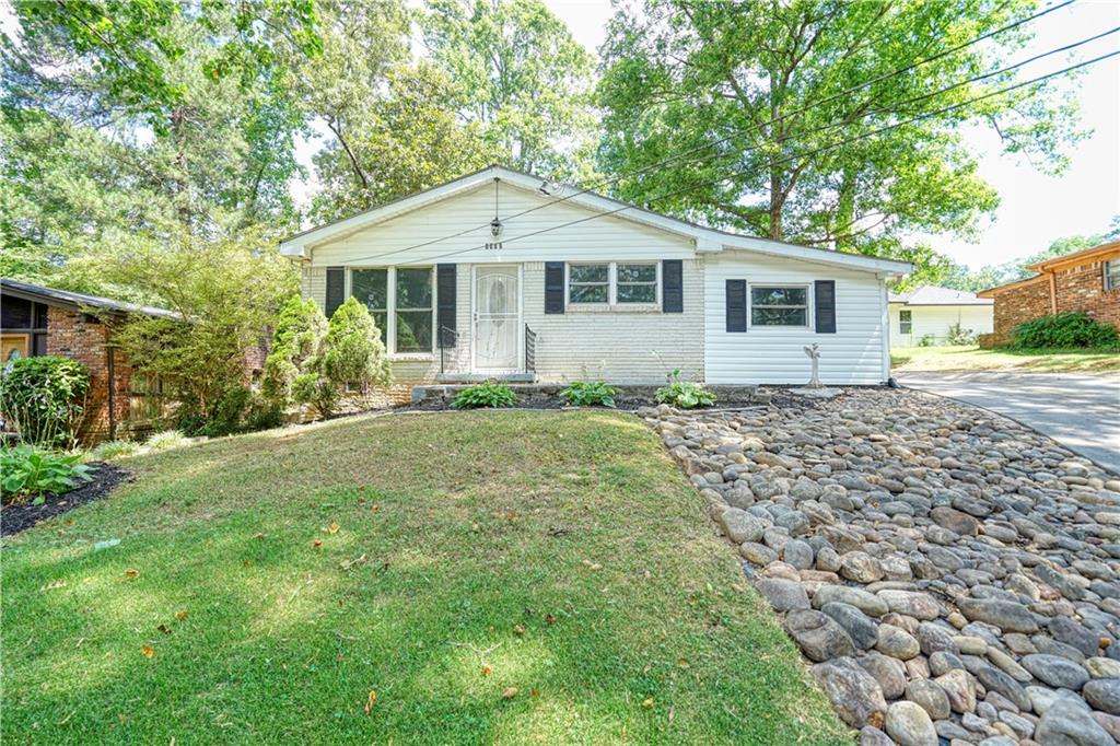 a front view of a house with a garden