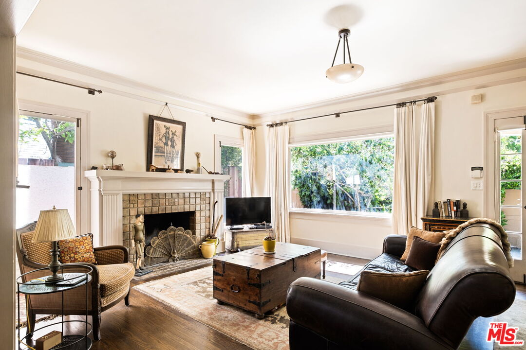 a living room with furniture fireplace and window