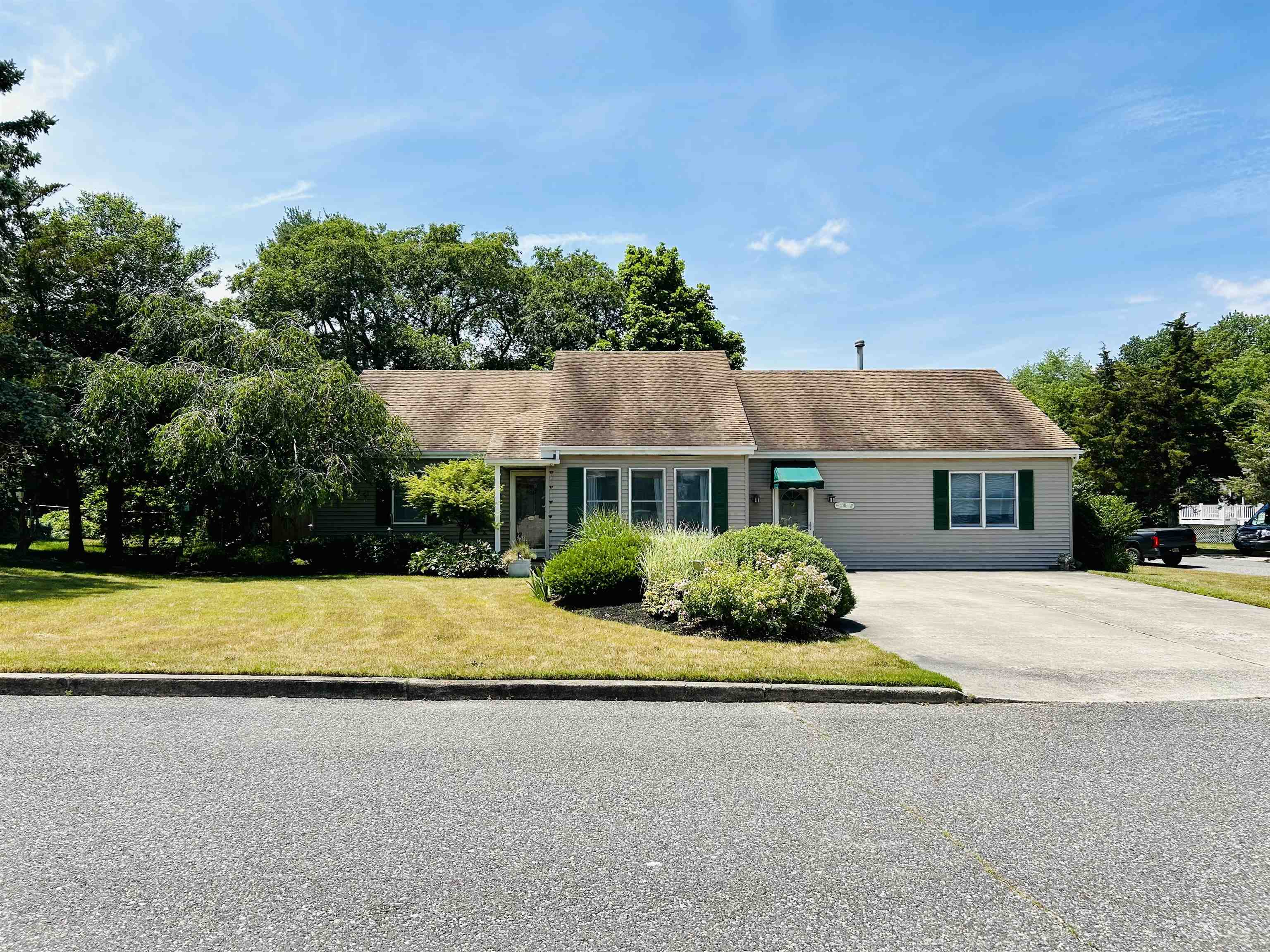 a front view of a house with a garden and yard