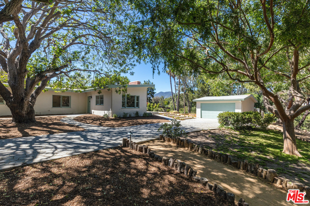 a view of a house with a tree