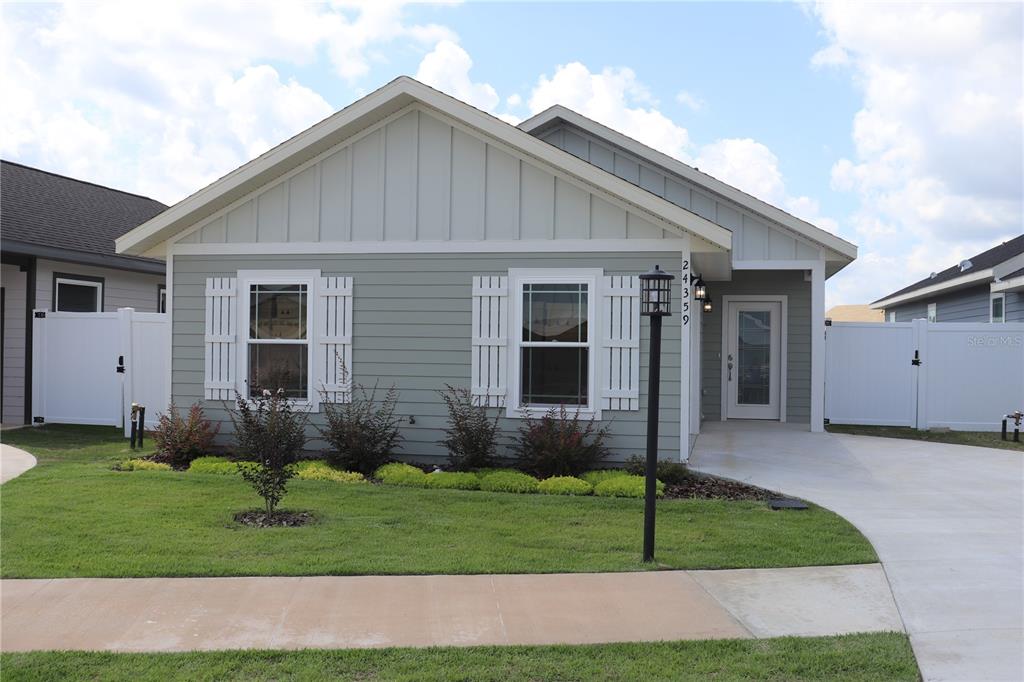 a front view of a house with a garden and yard