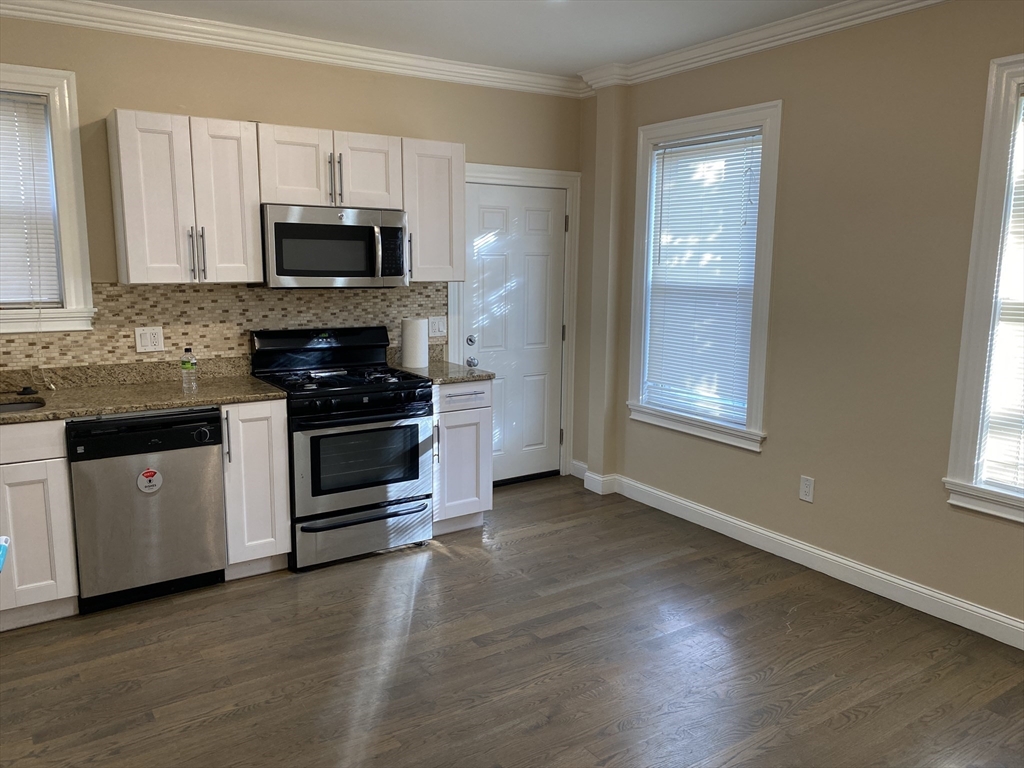 a kitchen with stainless steel appliances a stove a microwave and sink