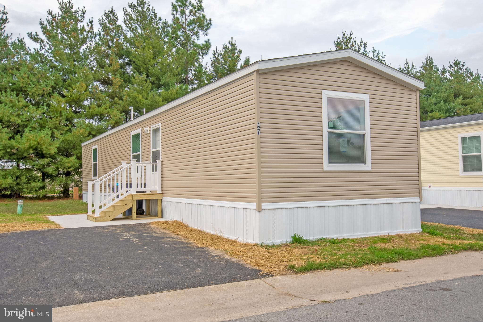 a view of a house with a yard and a garage