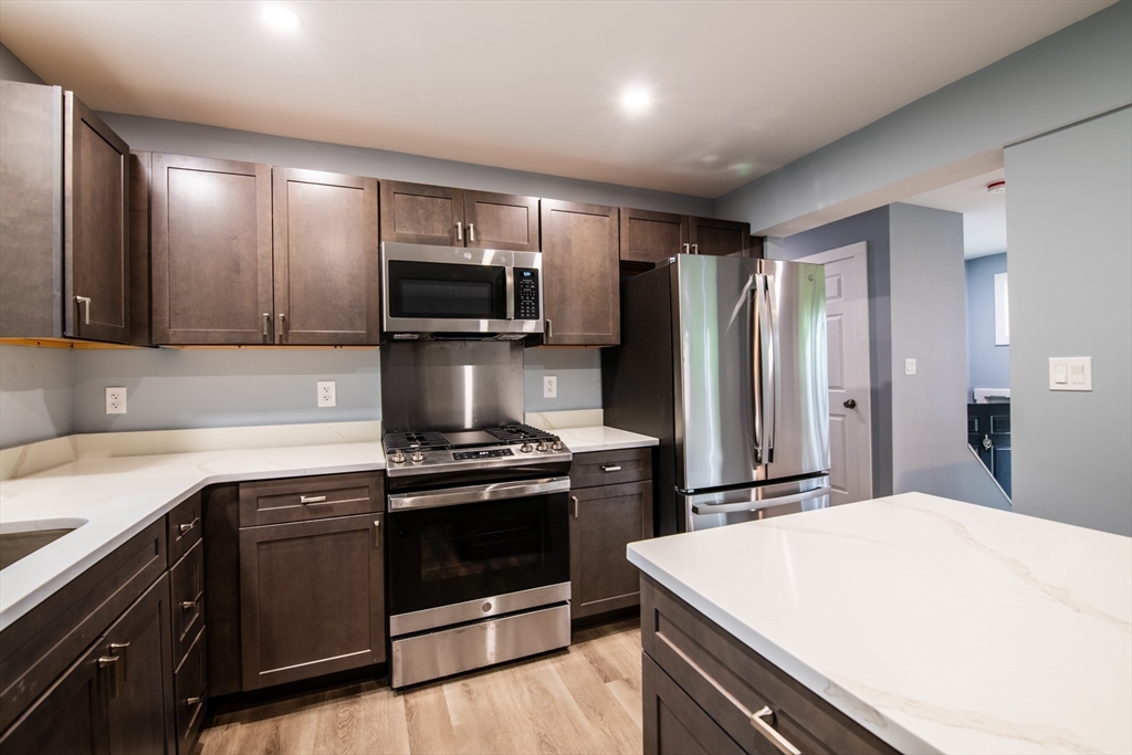 a kitchen with a stove and a refrigerator