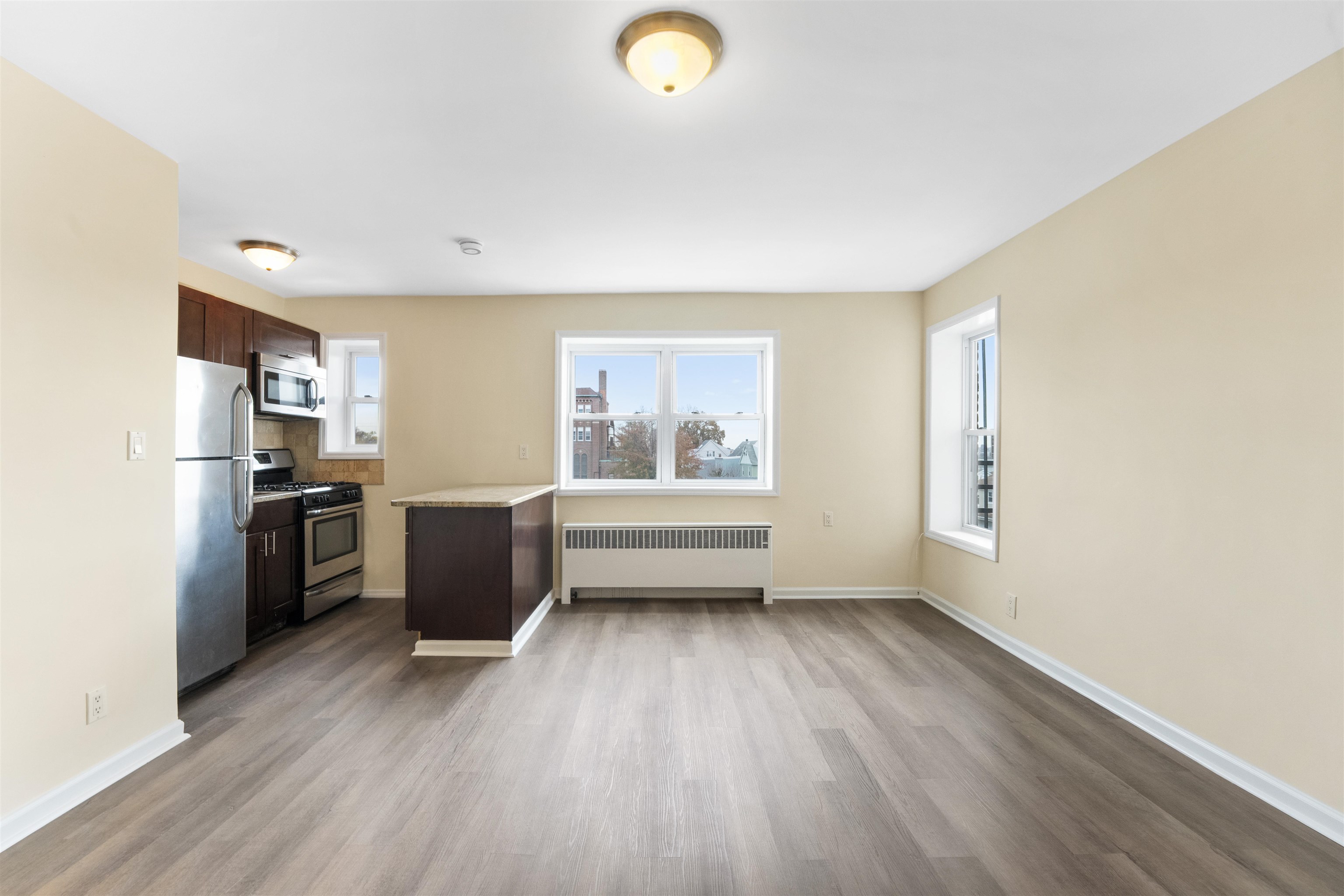 a kitchen with a refrigerator and a stove top oven