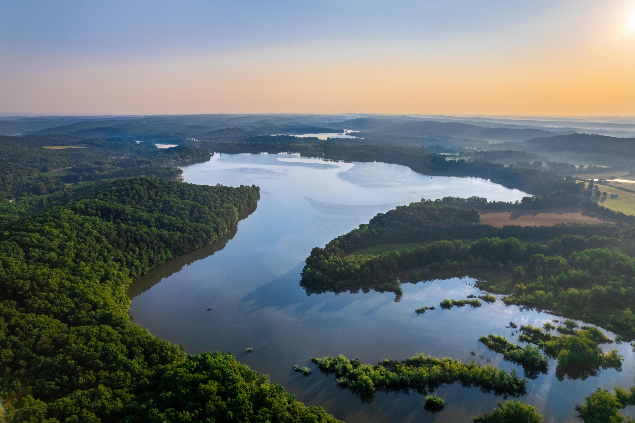 an aerial view of mountain with lake view