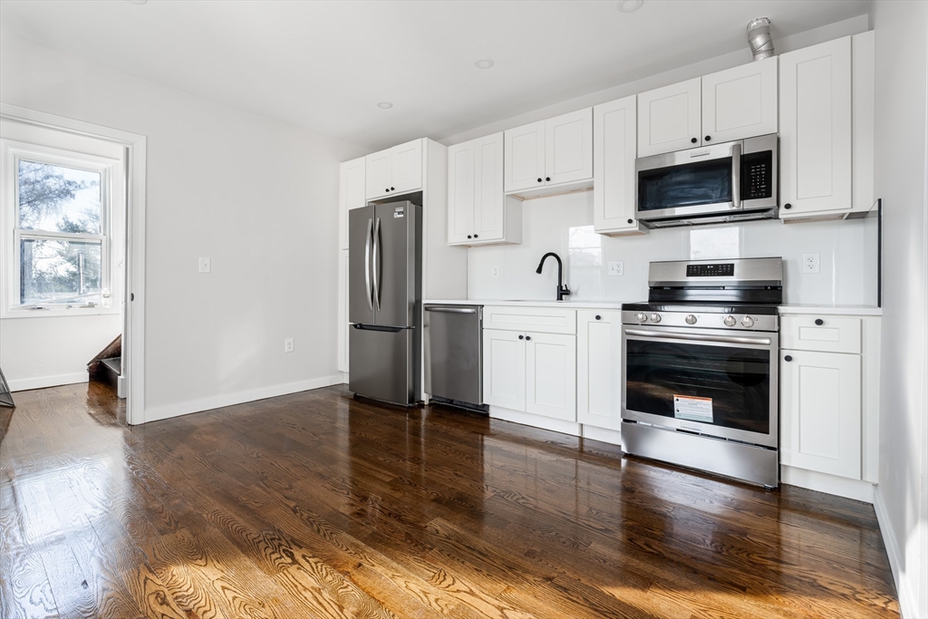 a kitchen with stainless steel appliances a stove a microwave and sink