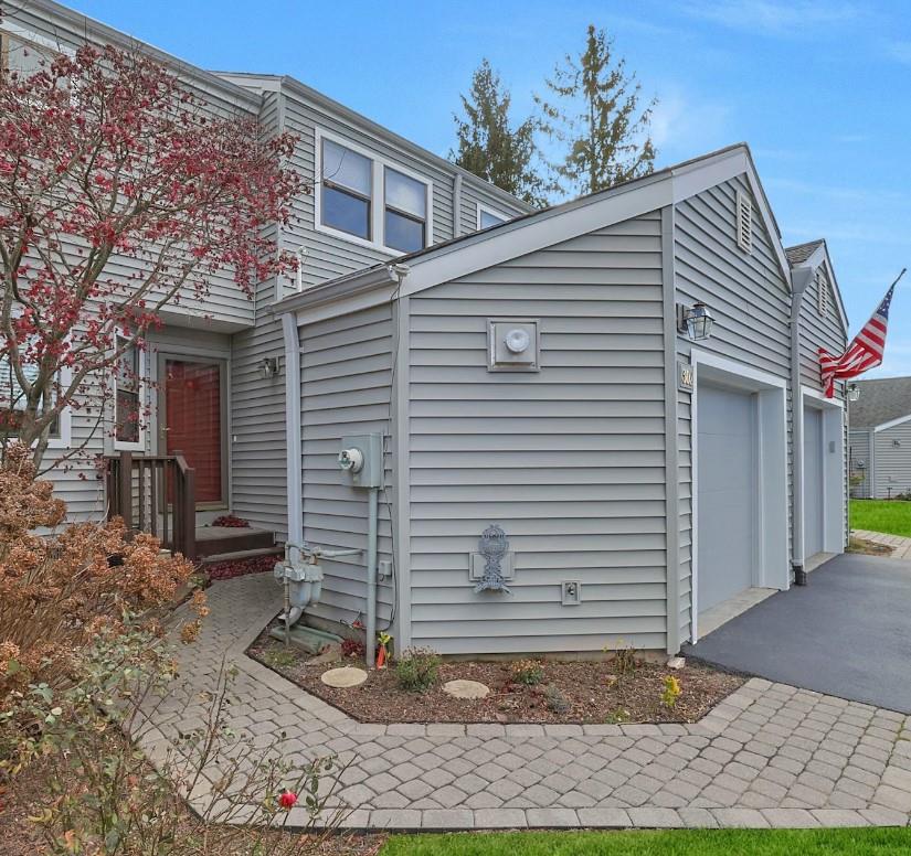 View of side of property with a garage