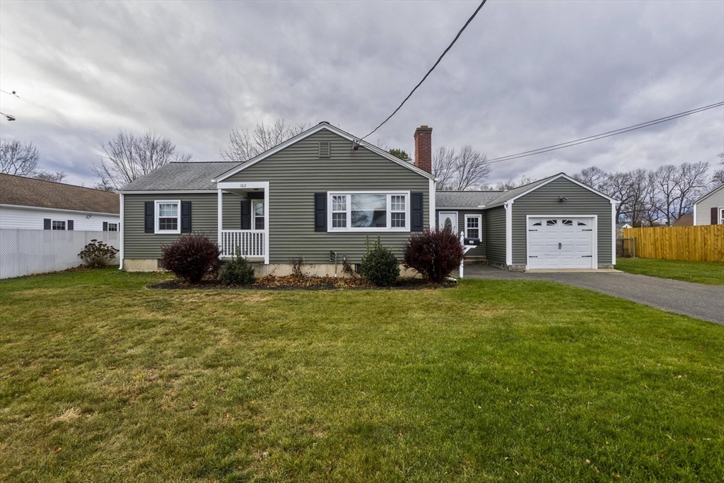 a front view of house with yard and green space