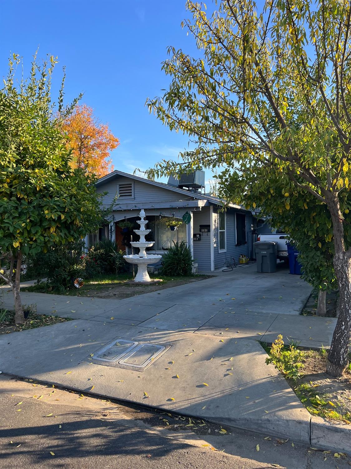 a front view of a house with a tree