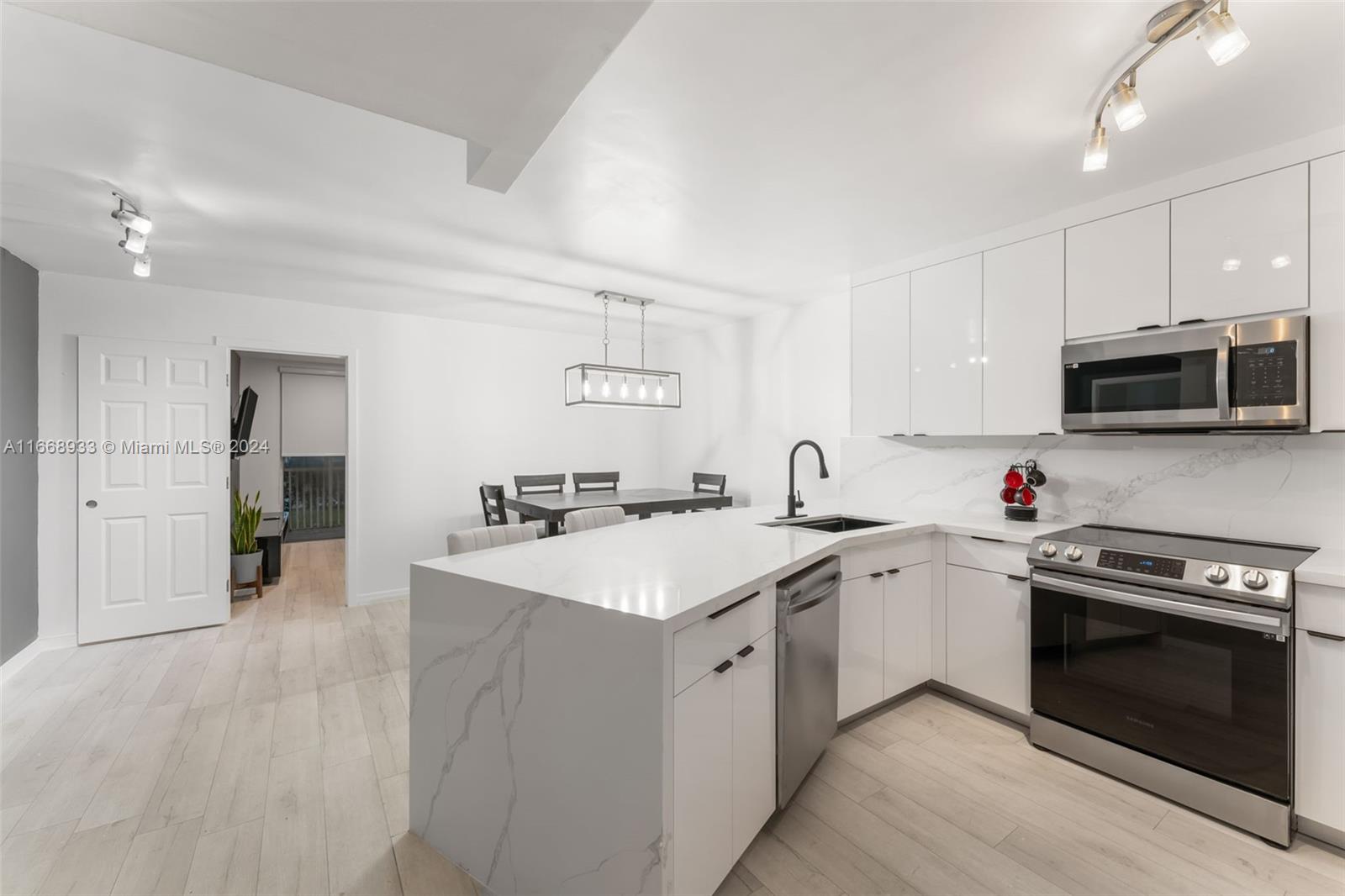 a kitchen with a sink stove and microwave