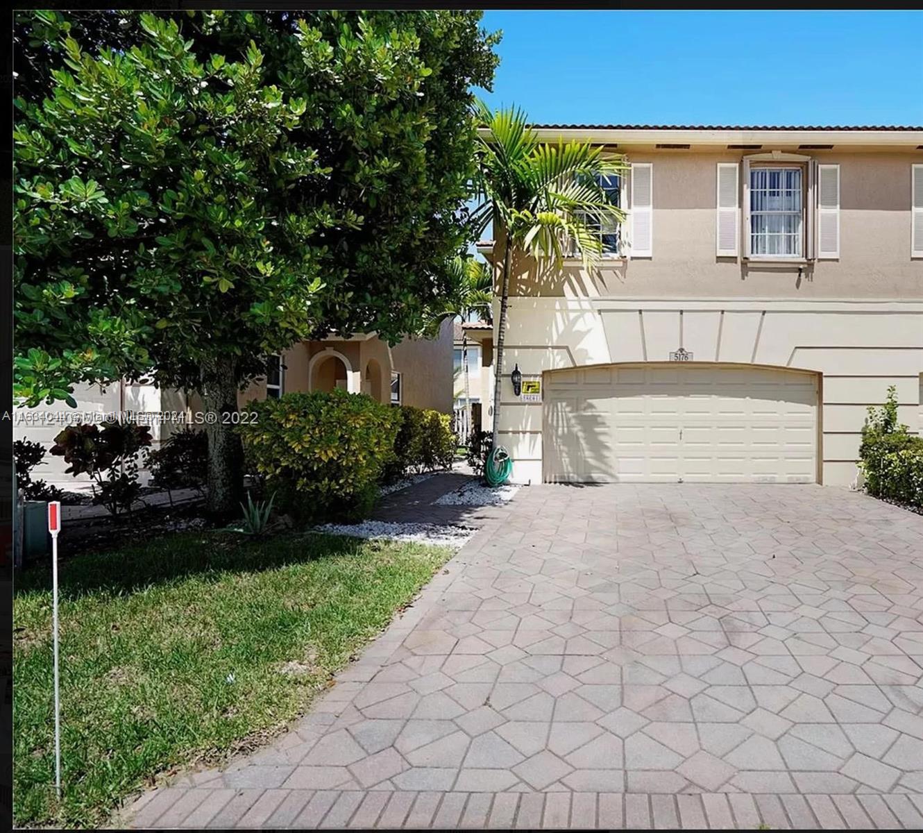 front view of a house with a garden