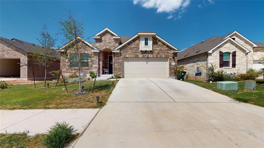 a front view of a house with a yard