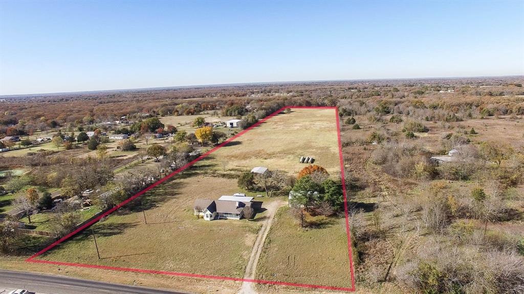 an aerial view of a house with a yard