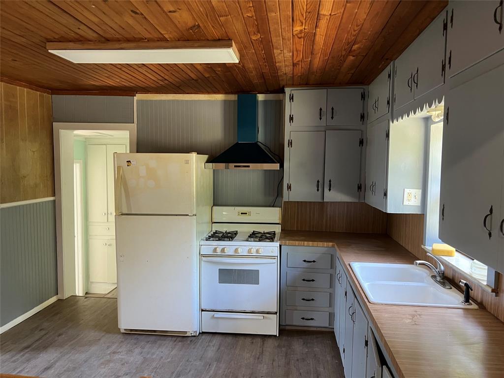 a kitchen with a stove and a refrigerator