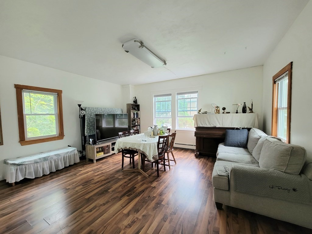 a living room with furniture and a wooden floor