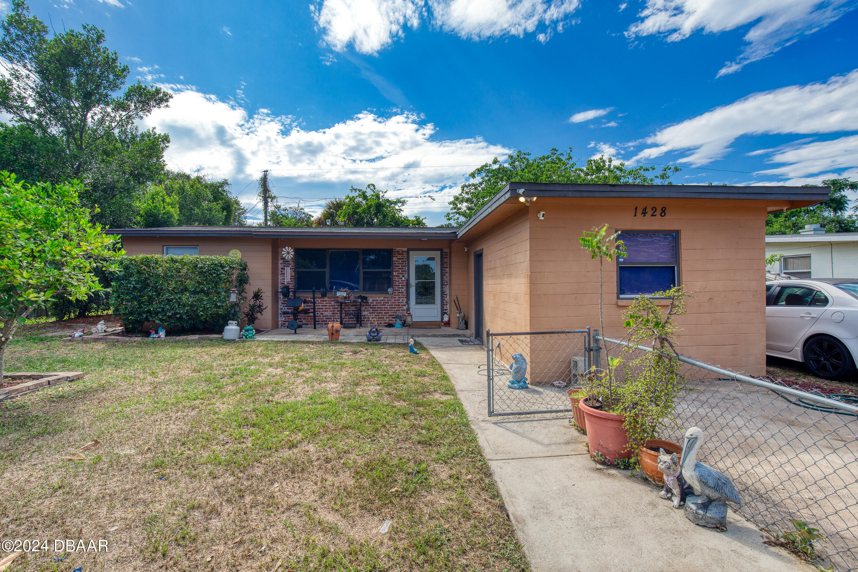 a view of a house with backyard porch and furniture