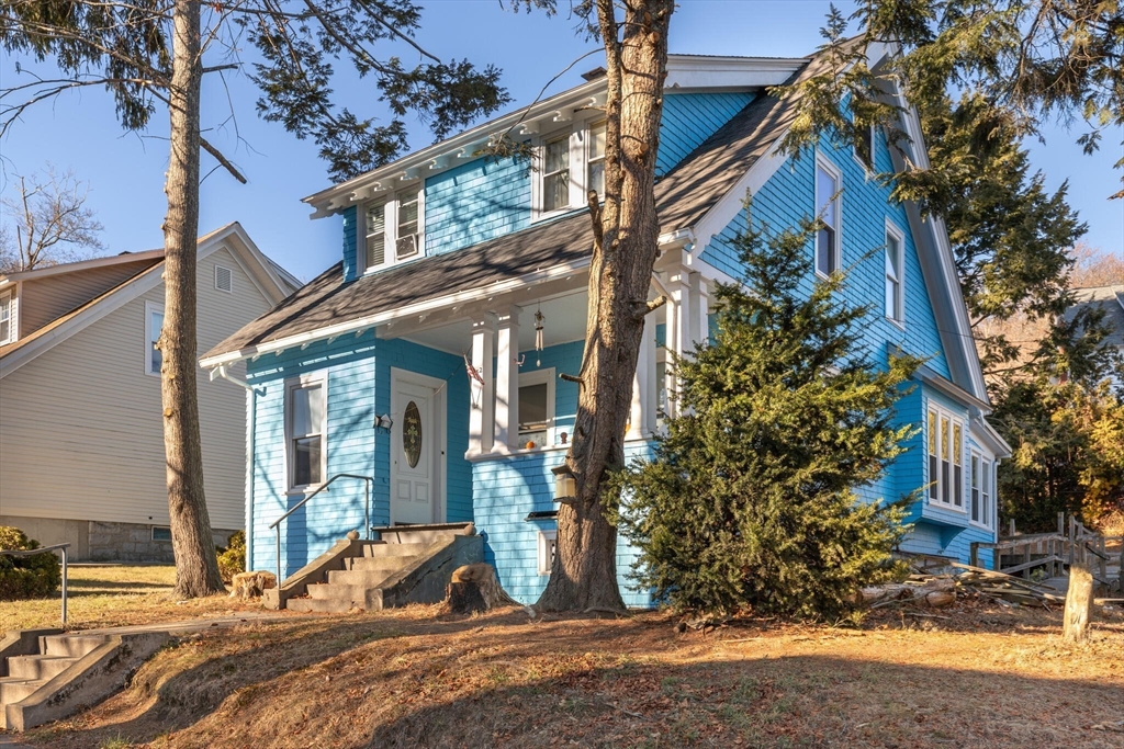 a view of a house with a tree