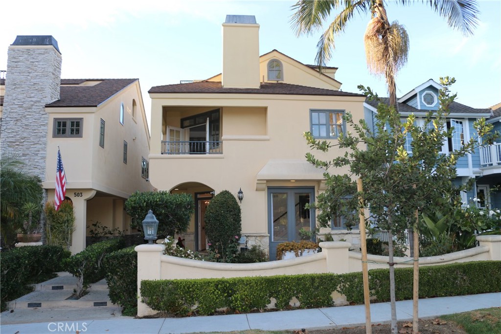 a front view of a house with garden and plants