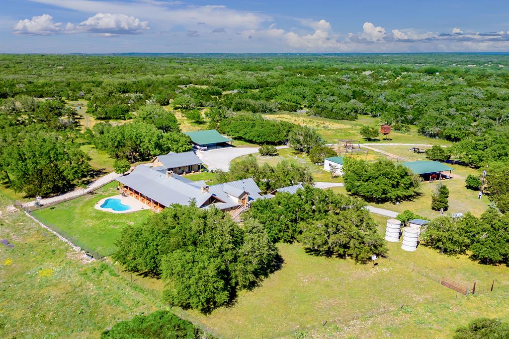 an aerial view of a house with a yard and lake view