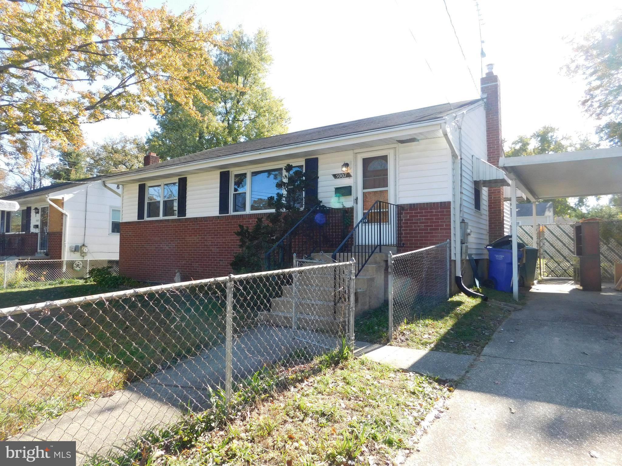 a view of a house with a wooden fence