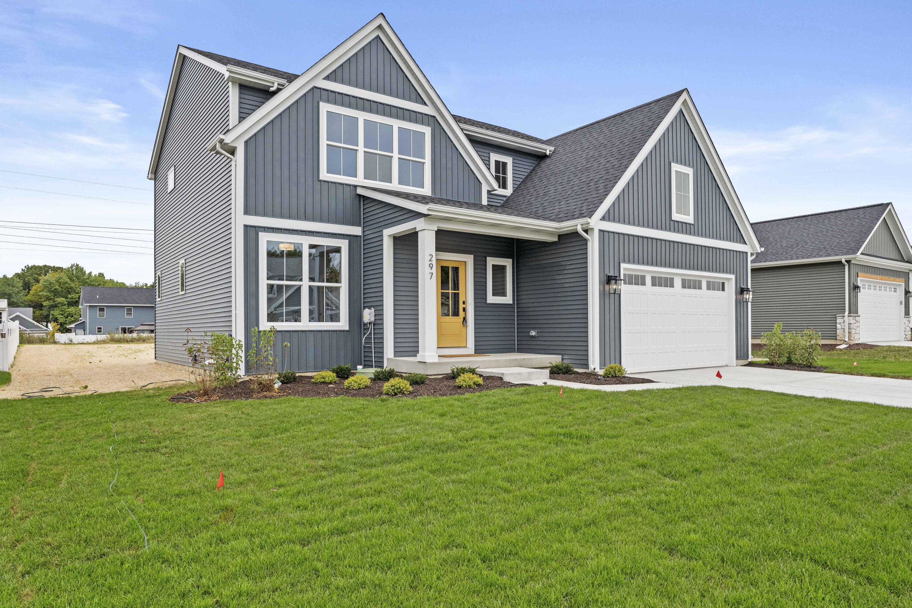 a front view of a house with a yard and garage