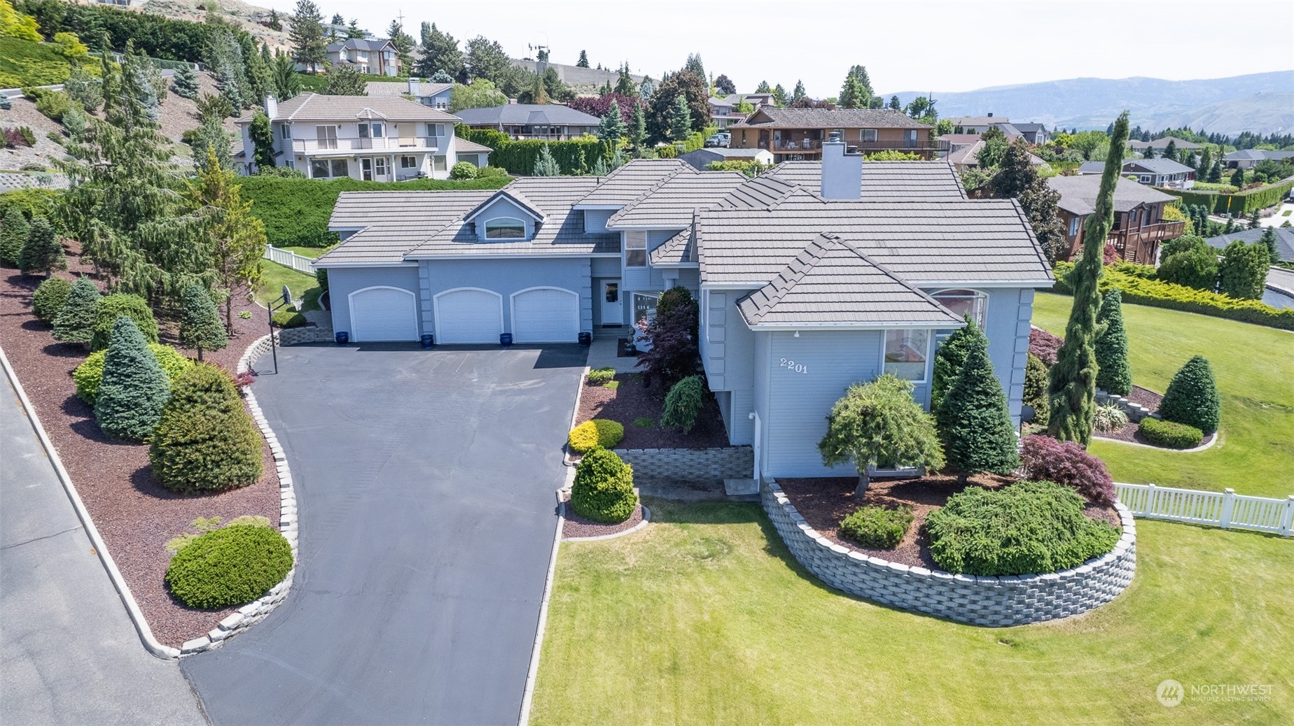 an aerial view of a house with a yard and plants