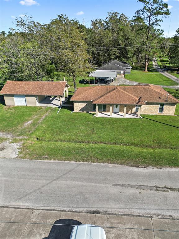 an aerial view of residential houses with outdoor space and street view