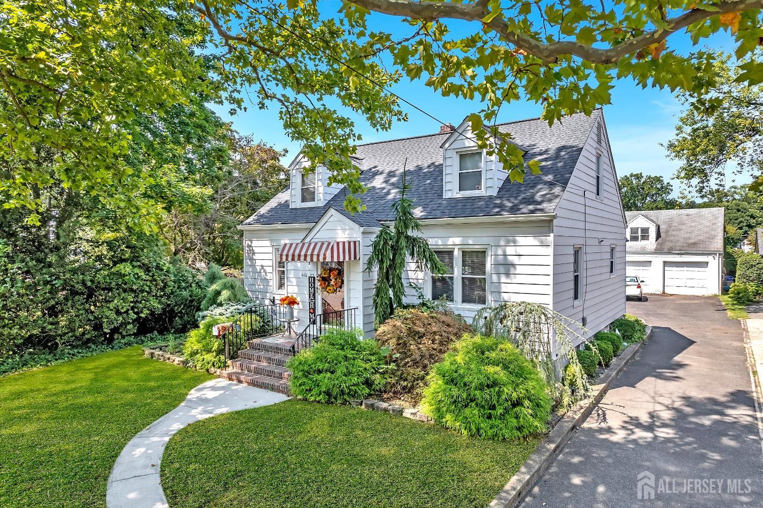 a front view of a house with a garden