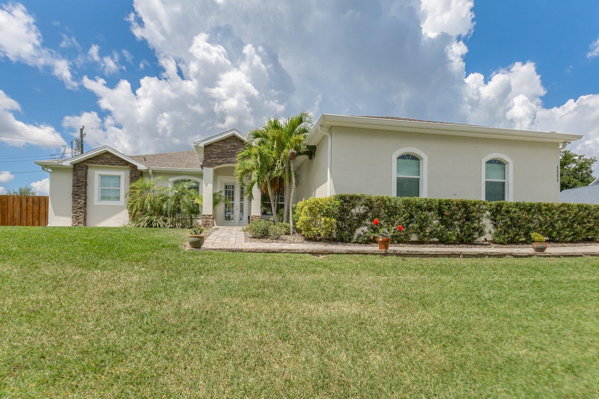 a front view of house with yard and green space