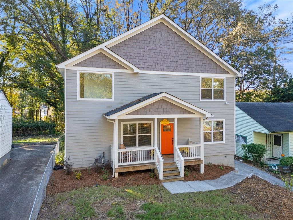 a view of a house with a yard chairs and a yard