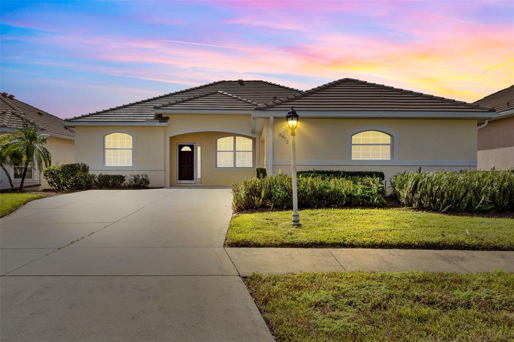 a front view of a house with a yard and garage