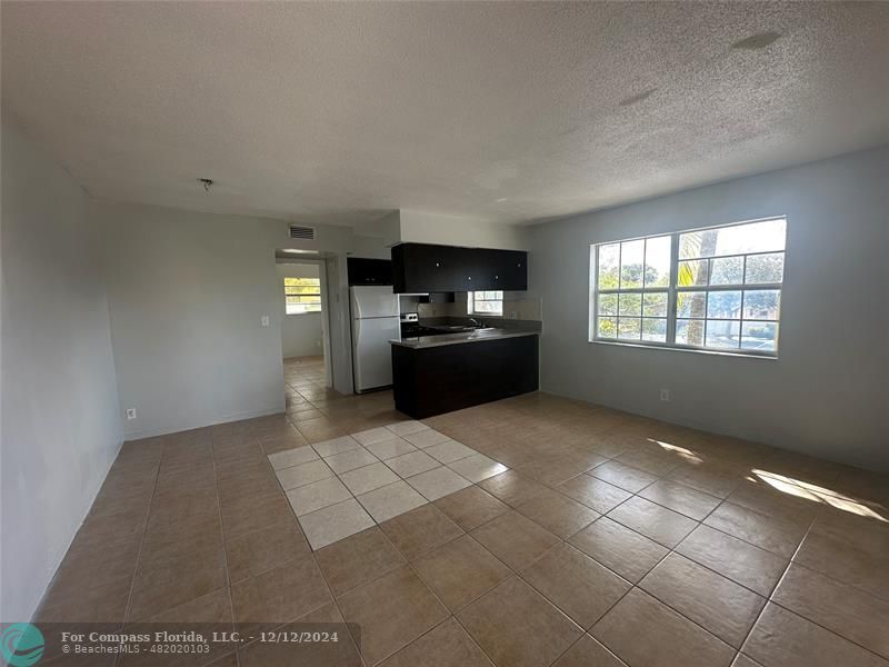 a kitchen with granite countertop a stove a microwave and a counter top space