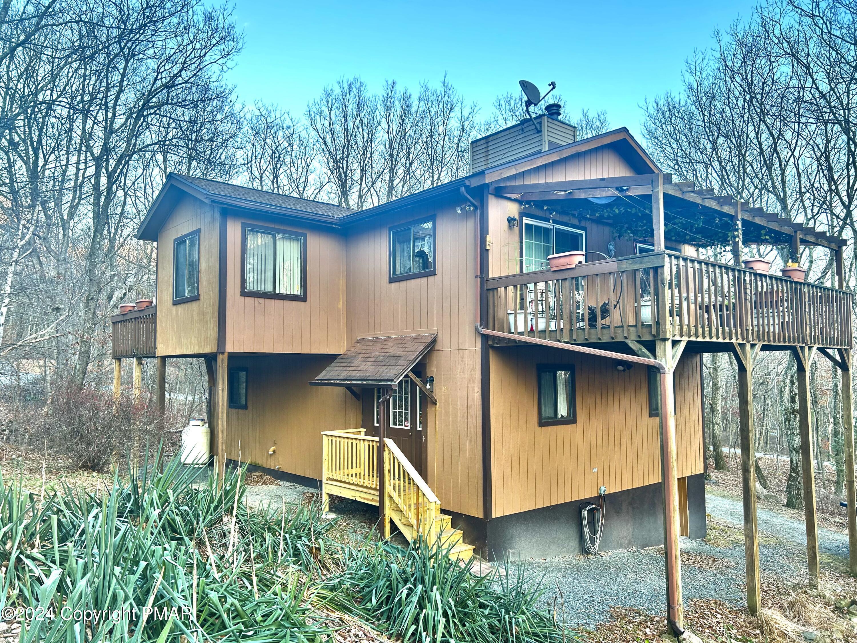 a view of a house with a yard balcony and furniture