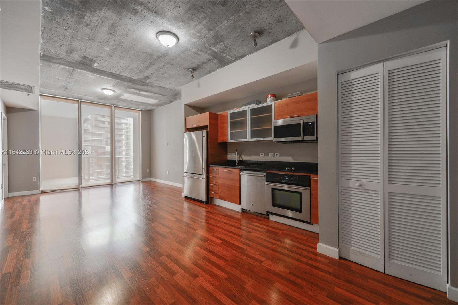 a kitchen with stainless steel appliances a stove and wooden floor