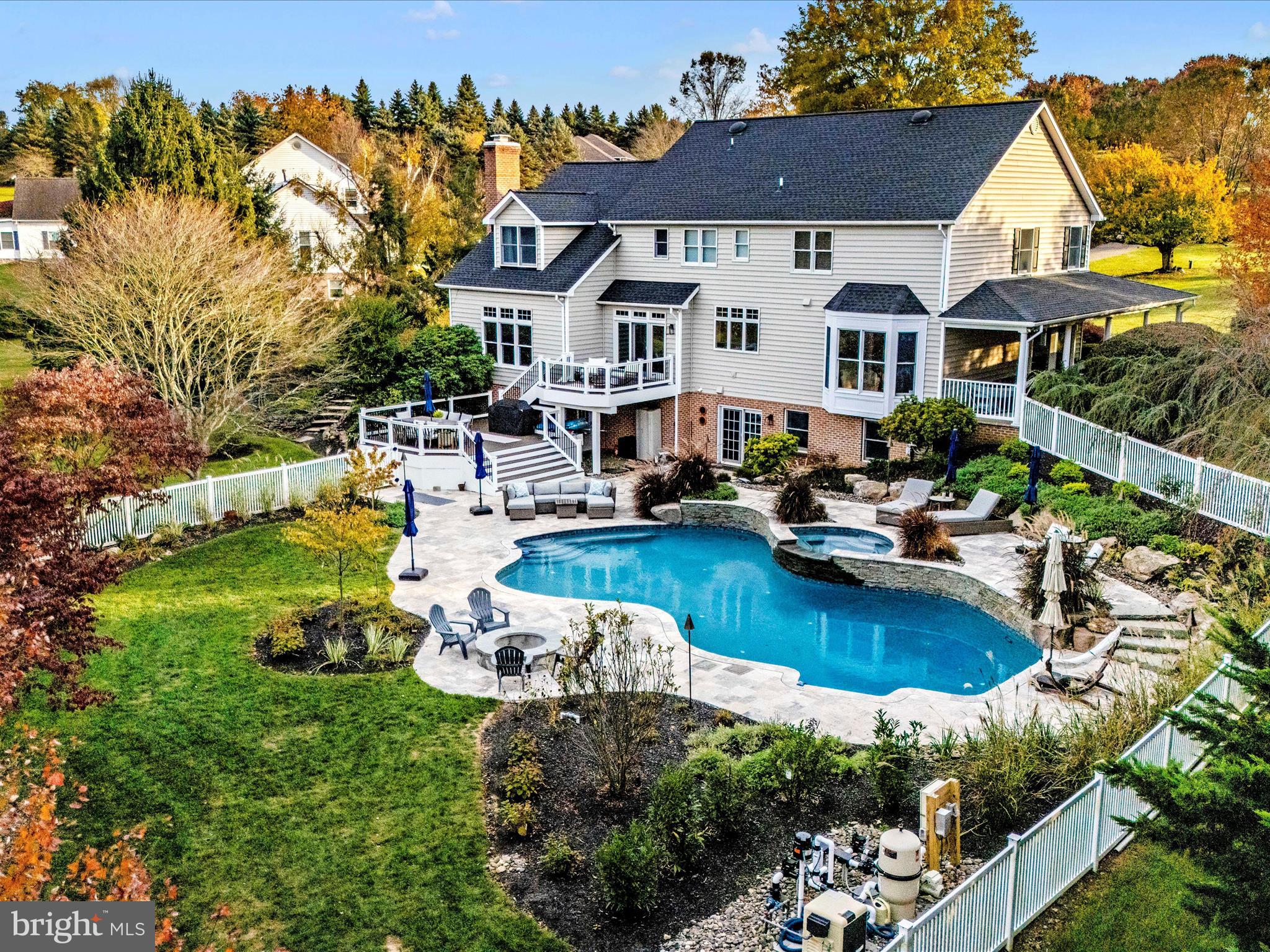 a aerial view of a house with swimming pool lawn chairs and a yard