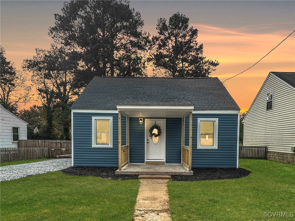 Bungalow-style house with a porch and a lawn