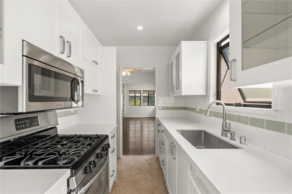 a kitchen that has a sink and a stove