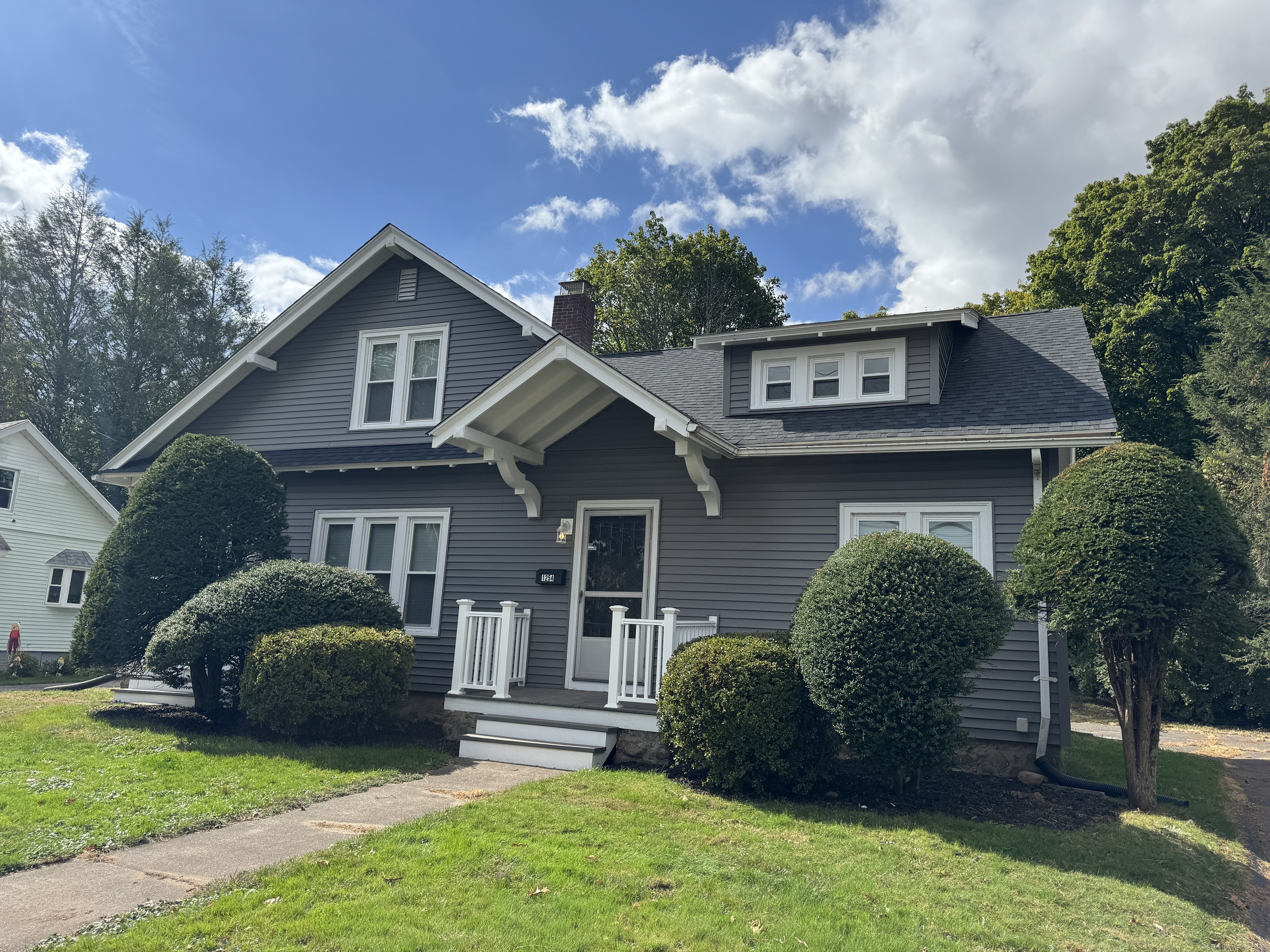 a front view of a house with garden