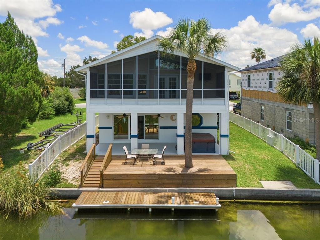 a view of a swimming pool with a patio and a yard