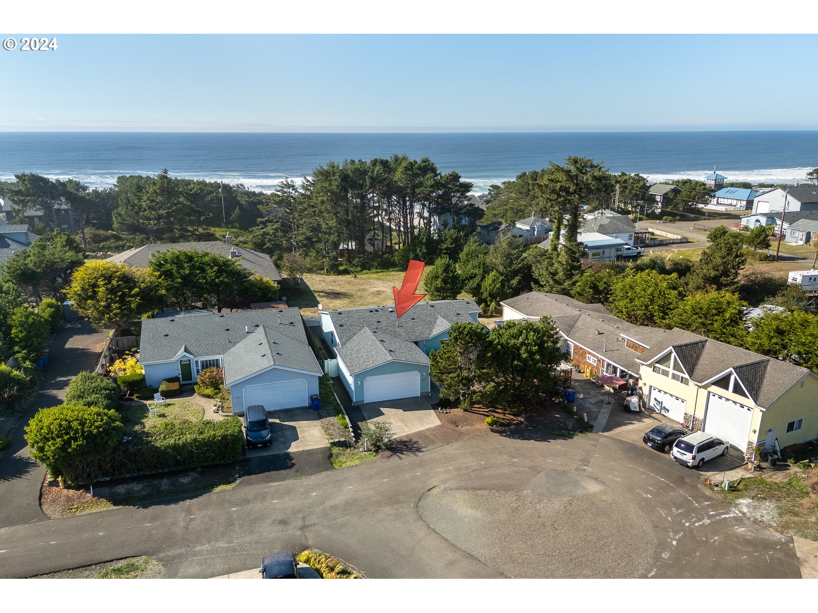 an aerial view of a house with a yard and lake view