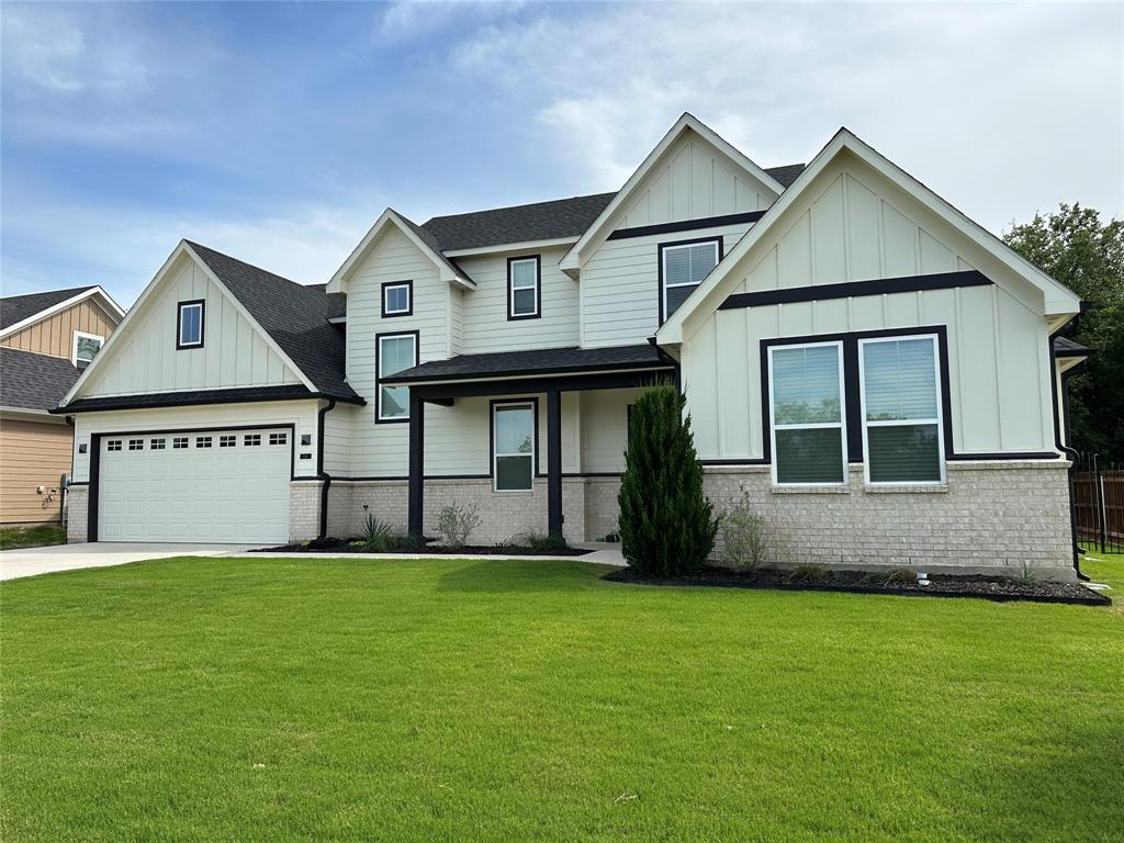 a front view of a house with a yard and garage