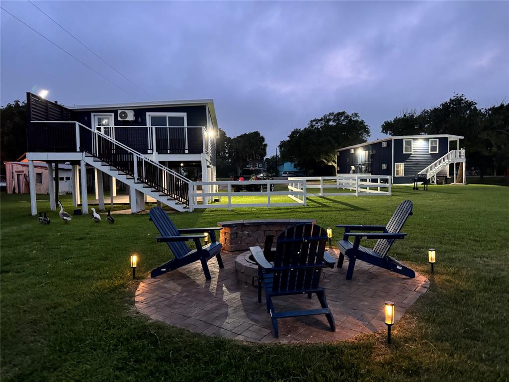 a view of a chairs and table in patio with a yard