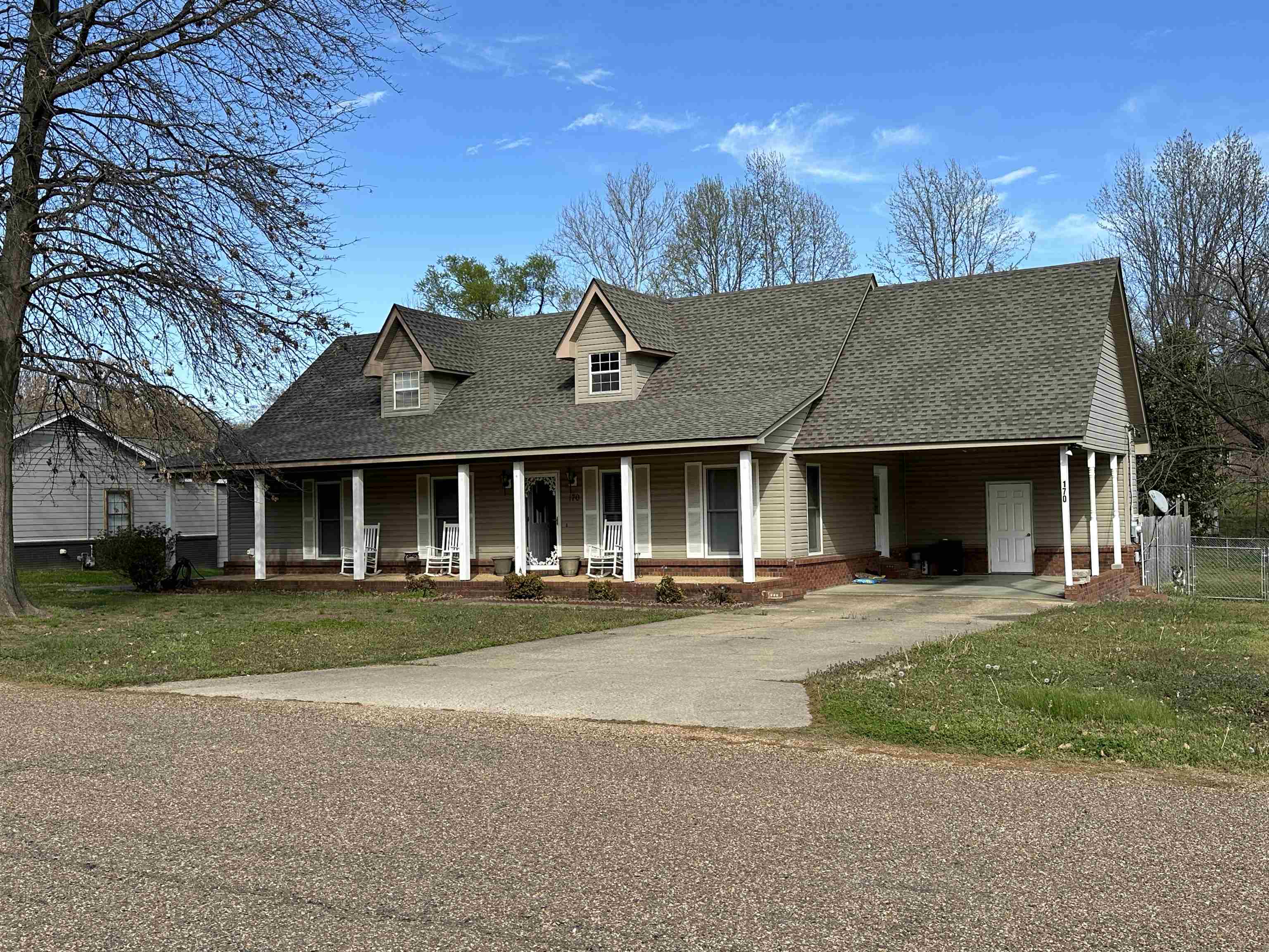 View of front of home featuring a porch and a front lawn