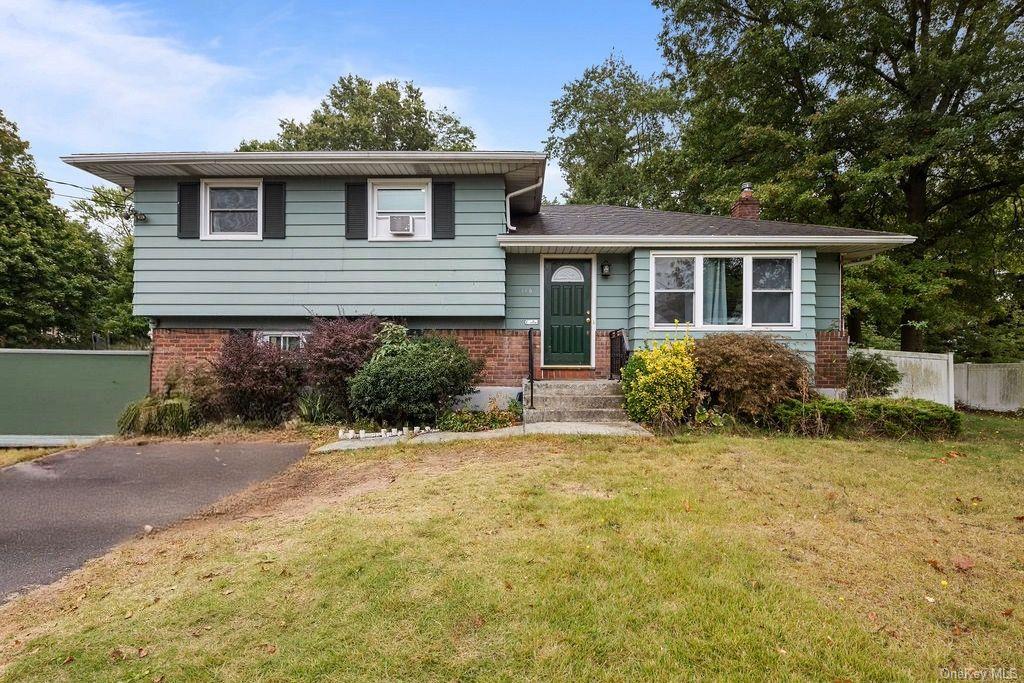 a front view of a house with a yard and potted plants