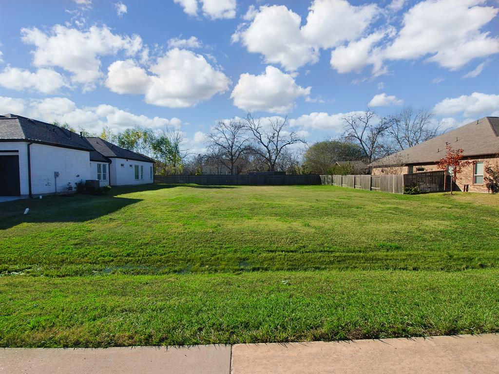 a view of yard with swimming pool and green space