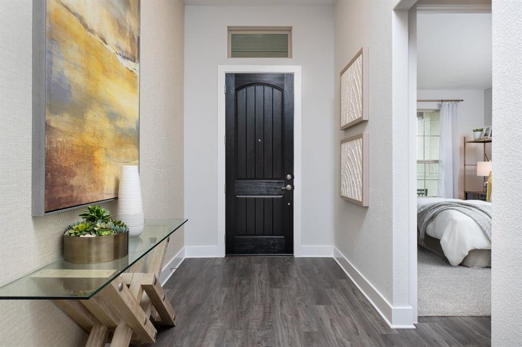 a hallway with front door and wooden floor