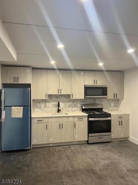 a kitchen with stainless steel appliances a sink stove and cabinets