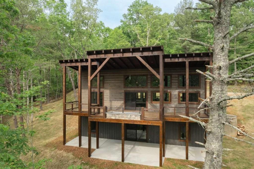 a view of backyard of house with seating space