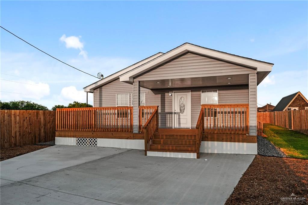 a view of backyard with tub and wooden fence